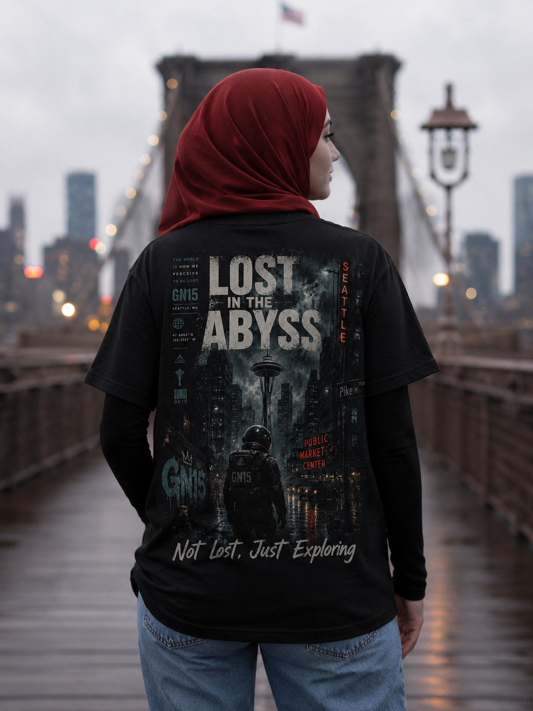 Woman wearing GN15 Lost in the Abyss Seattle streetwear t-shirt with red hijab, black long sleeves, and blue jeans on Brooklyn Bridge.