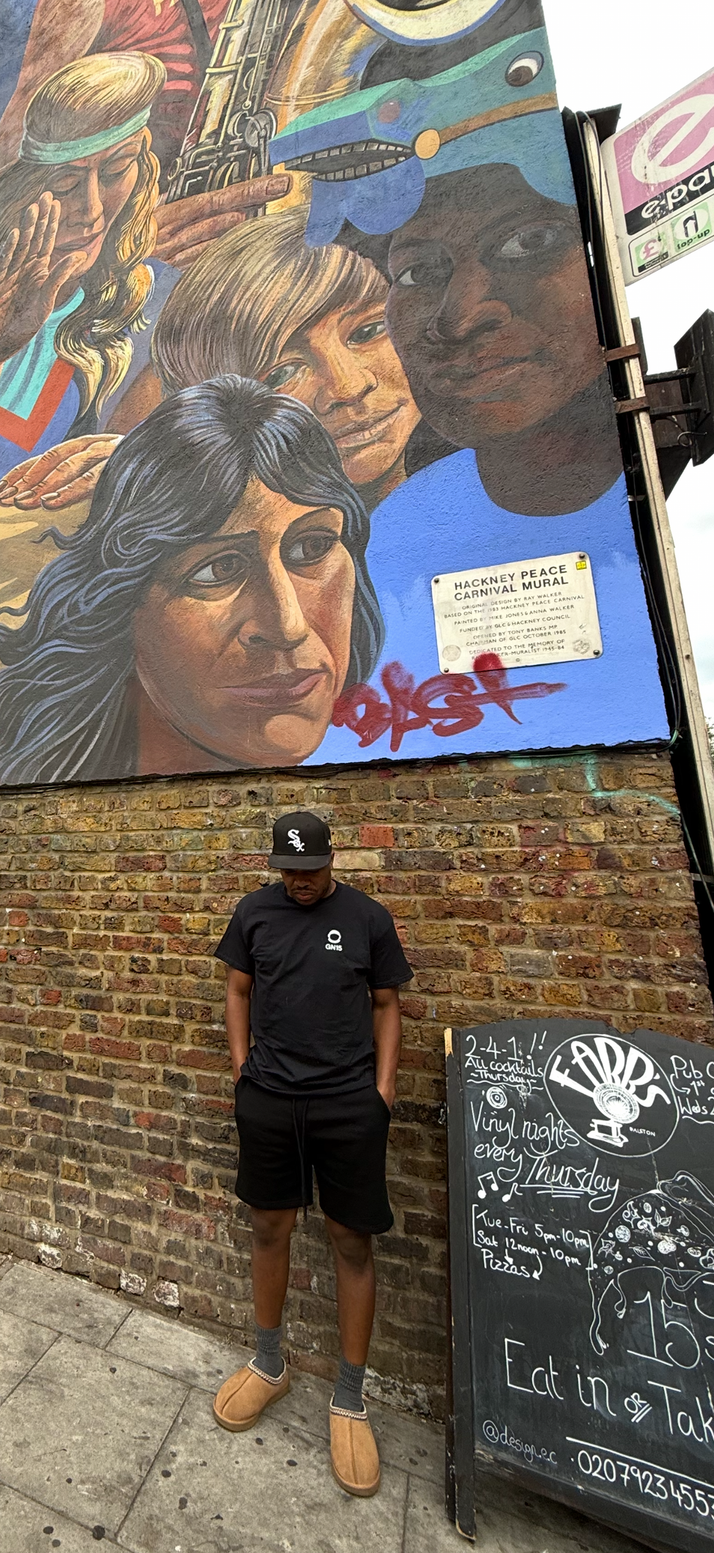 Model wearing the black GN15 Cosmic Reflection tee with a small white chest logo